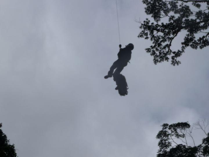 Darrin Hitchman being winched up to Helicopter